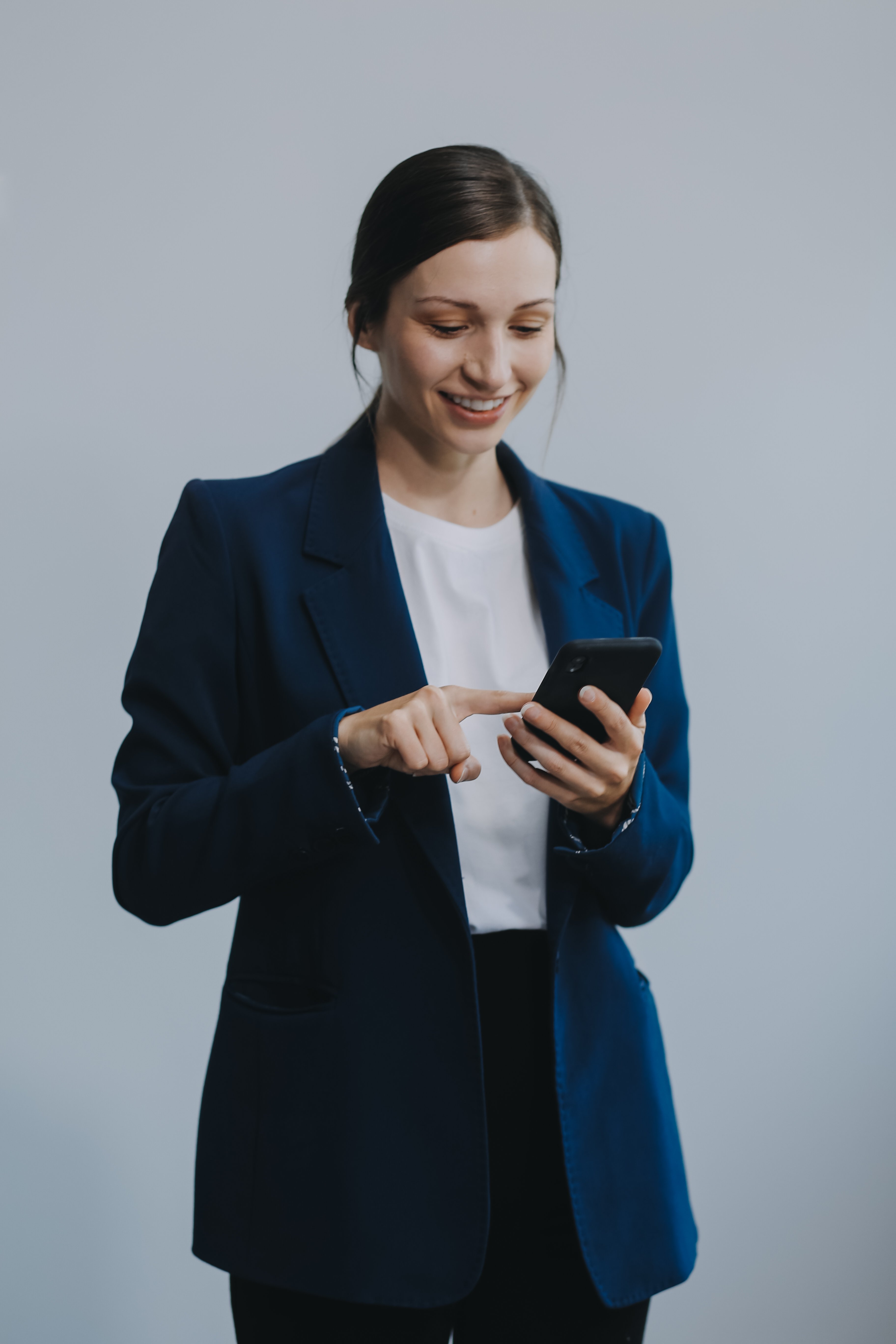 portrait-happy-asian-businesswoman-using-mobile-phone-isolated-white-background
